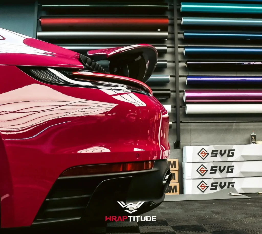 Red car vinyl wrap next to wrack of SVG vinyl wrap